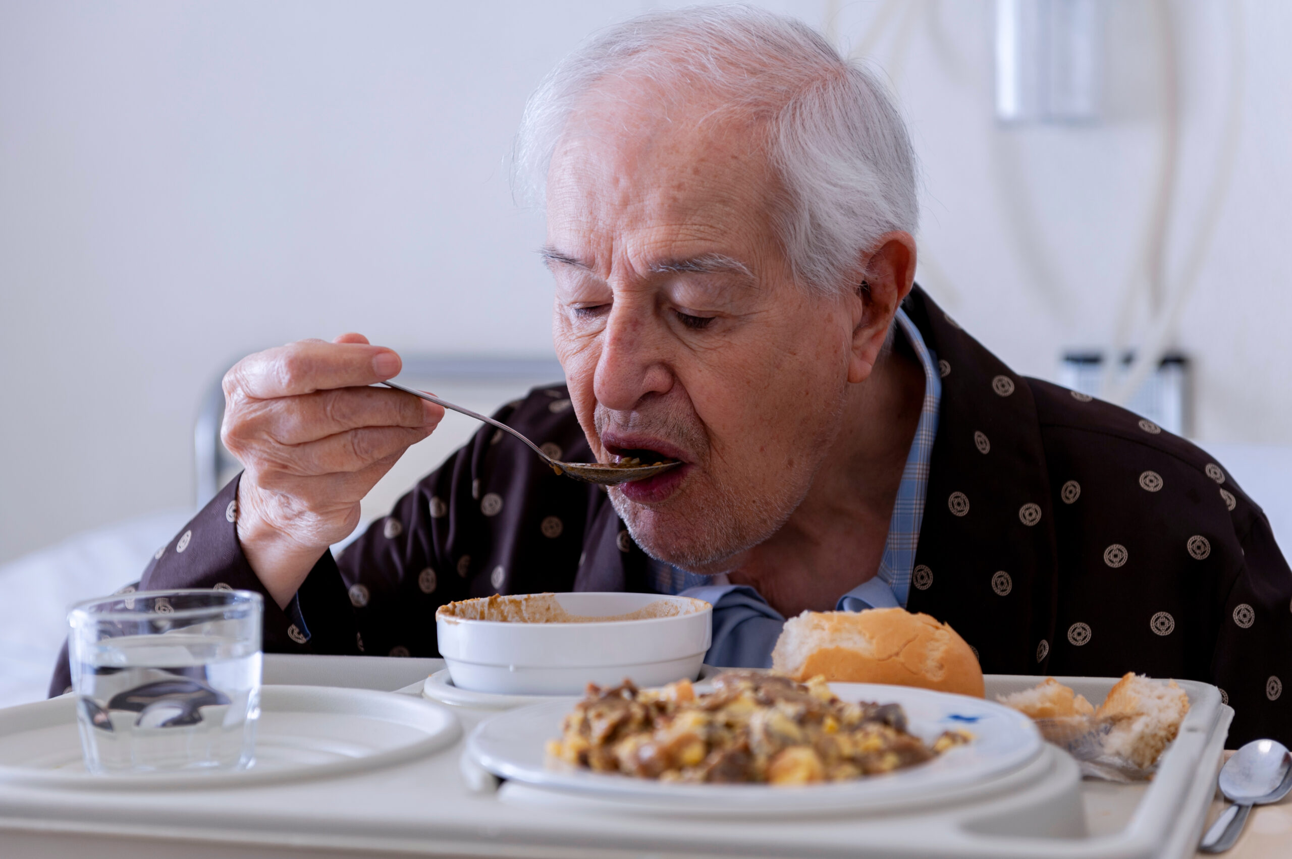 Elderly man possibly having swallowing problems at home